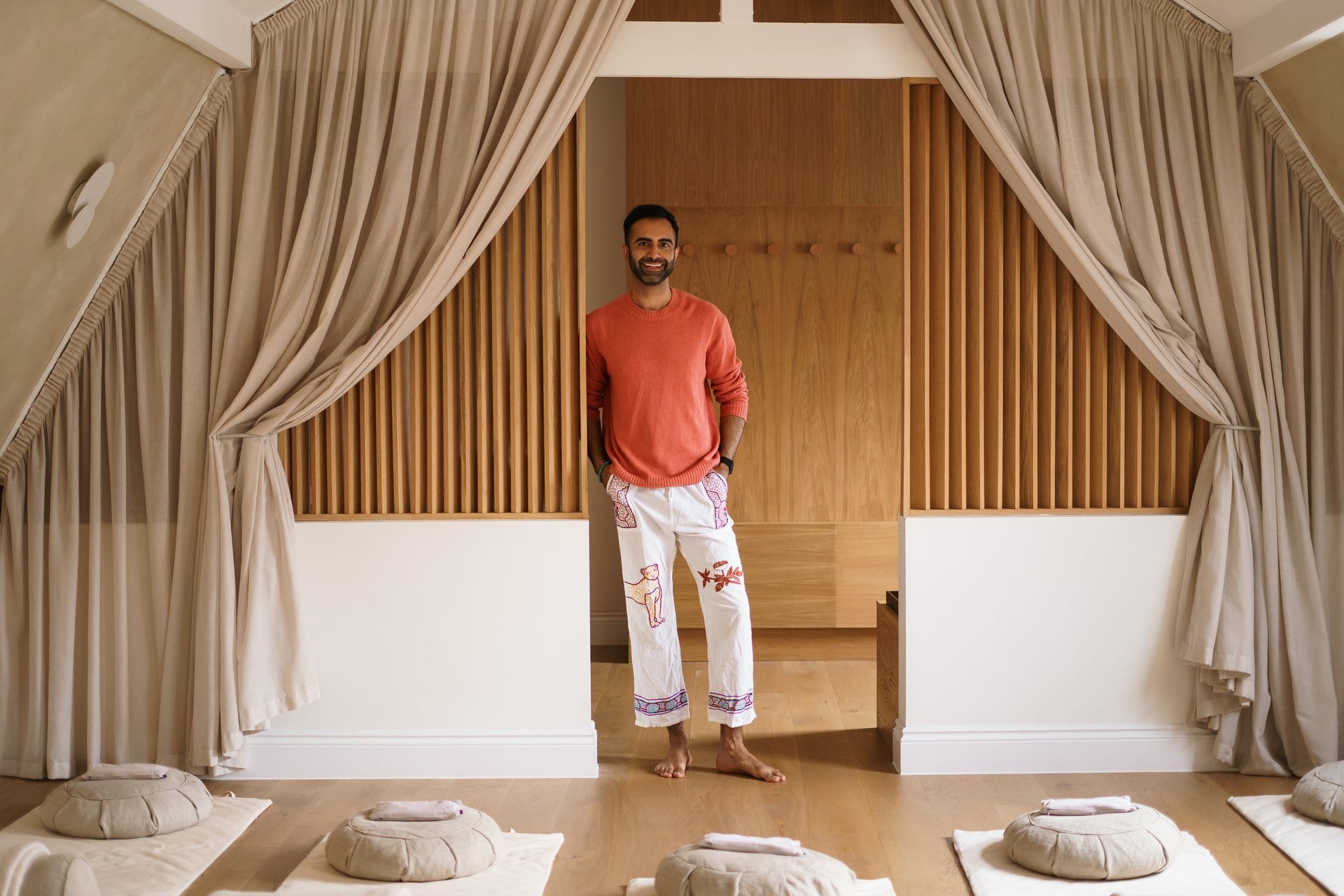 Ryan Samtani smiling in the breathwork studio